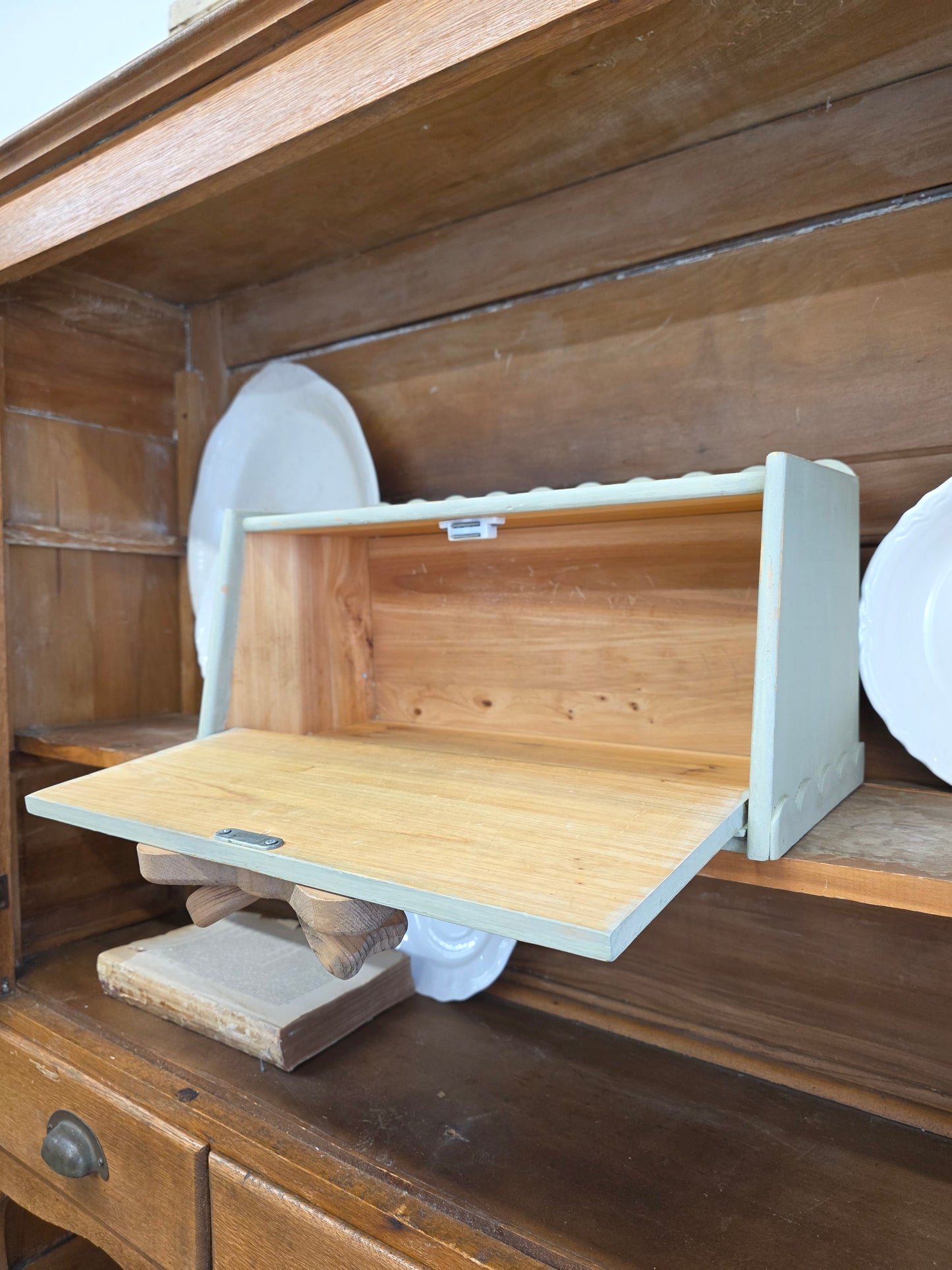 Green breadbox with scalloped details and large wooden bow