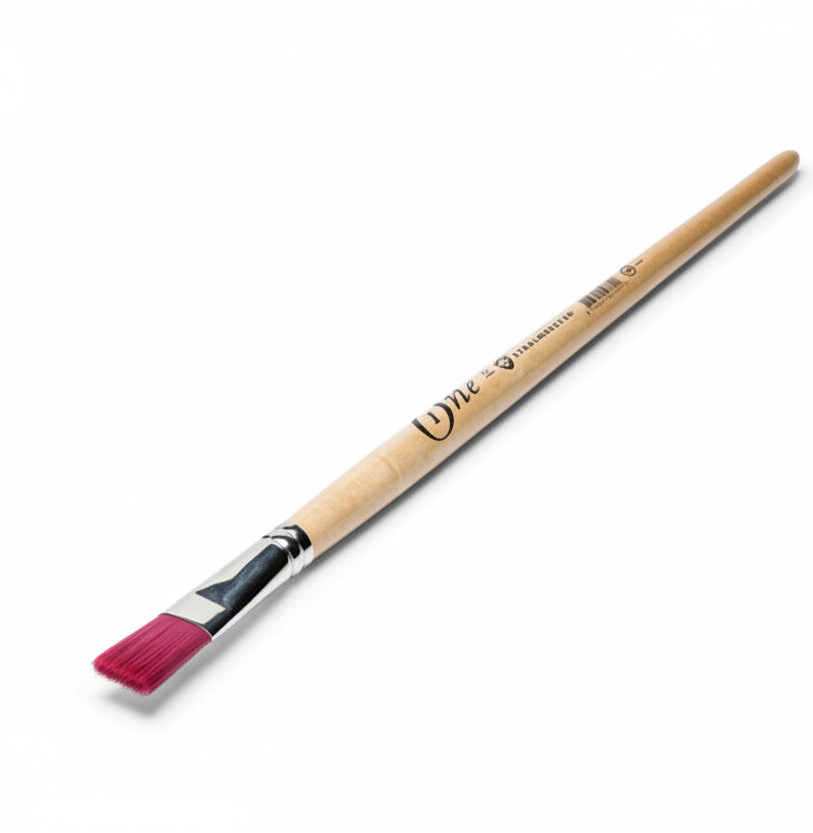 Paintbrush with pink bristle head on a white background