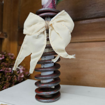 chippy red metal spring with Christmas embellishments