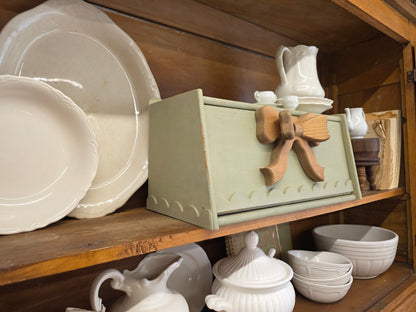 Green breadbox with scalloped details and large wooden bow