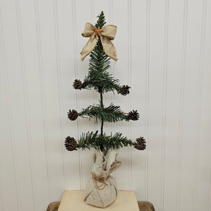 handmade vintage style Christmas tree with pinecones and bow